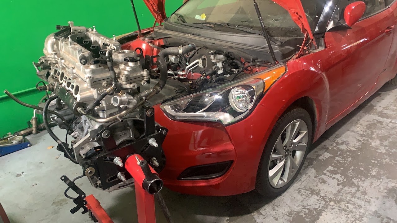 Auto Mechanic Express technician performing engine repair work in the shop