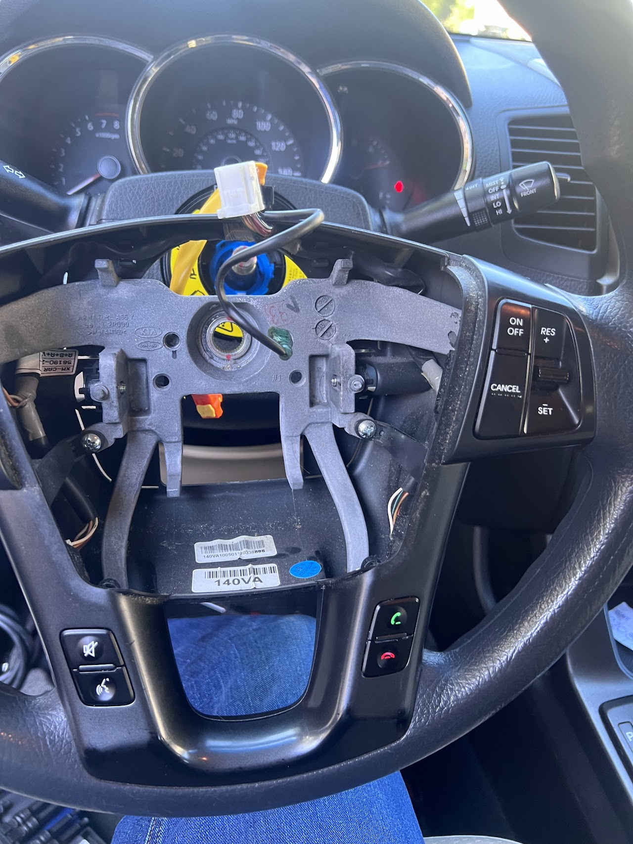 Professional auto technician using a digital diagnostic tablet to inspect a vehicle engine